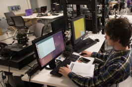 A student working on a computer at UNH's IOL