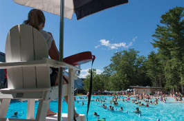 a lifeguard watching people swimming at UNH's new outdoor pool
