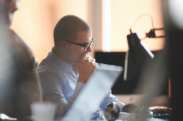 man looking at a computer in an office