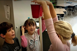 Fourth graders at East Rochester School try some engineering skills to make a rollercoaster out of household items with the help of UNH STEMbassadors on Friday (Photo by John Huff/Fosters.com)