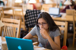 UNH student at her computer in Dimond Library 