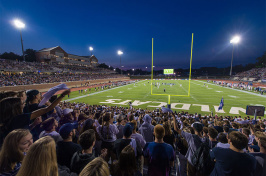 fans cheering during the first football game at UNH Wildcat Stadium