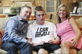 Brian Long, left, and Kim Long, right, with their son Brennan Long last year. Brennan was left with two shattered thigh bones after being restrained by a staff member in his Louisville school in 2014. —Sam Upshaw Jr./Louisville Courier-Journal-File