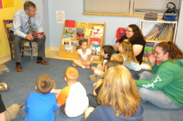 John Bragg, president of N.H. Bragg and Sons, reads a book to students at the Head Start Center at Eastern Maine Community College in a 2011 file photo.