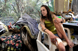 Billie Jo leans back at her homeless encampment on Bureau of Land Management land near unincorporated Cameron Park in El Dorado County, CA