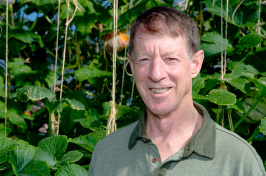 UNH emeritus professor Brent Loy in front of some vines