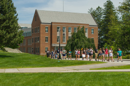 UNH campus with students walking along path