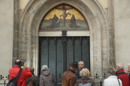 In 2016, visitors stand in front of the cast metal reproduction of Martin Luther's 95 theses in the doorway where in 1517 Luther originally nailed his theses at the Schlosskirche church in Wittenberg, Germany Sean Gallup—Getty Images