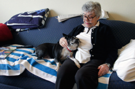 Elizabeth Kennedy pets her dog, Dolly, in her living room at TigerPlace, a retirement community in Columbia, MO.