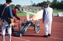 UNH alumnus Dick Dewing ’53 and assistants shoot off the cannon at a UNH football game