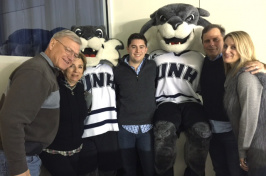 UNH Paul College graduate Kevin Knarr and others at a UNH hockey game