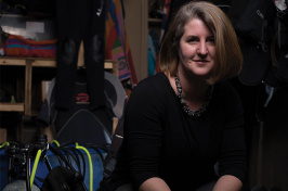 Kristin Duisberg in a closet with some SCUBA gear