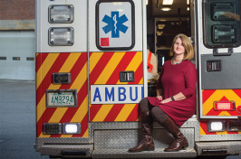 Kristin Duisberg sitting on the back of a McGregor EMS ambulance