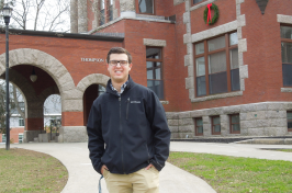 UNH student Jack Hamilton '20 in front of Thompson Hall on the Durham campus