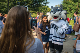 UNH student takes a photo with Wild E. Cat