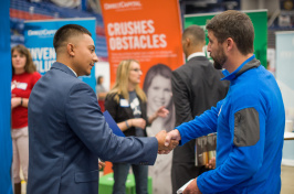 student and employer shake hands at the fall 2017 Career and Internship Fair