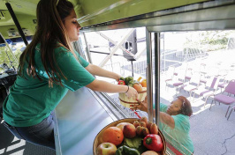 A student studying business and his wife studying social work teamed up on a plan to retrofit buses as mobile markets to bring nutritious offerings to "food deserts." (EPA/Newscom)
