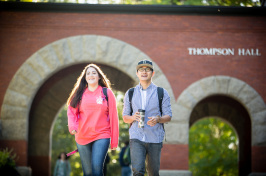 Students walking under the Thompson Hall arch at UNH 