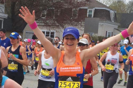 UNH student and runner Katie Litwinowich Meinelt ’03, ’04G crossing the finish line at the Boston Marathon