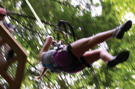 a UNH Cooperative Extension 4-H member using a zipline at Candia Springs