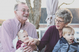 Image of grandparents holding two babies