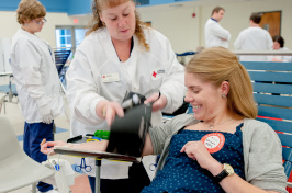 Woman donating blood at UNH blood drive