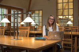 UNH student Charlotte Harris in the library on the Durham campus