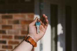 Image of a person  holding a key to a house