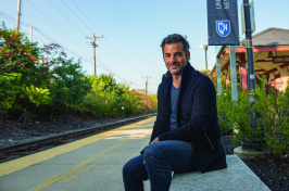 Jim Curtis poses for portrait photo on a bench on the UNH Durham campus.