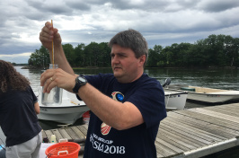 Kai Ziervogel holds flask of water and thermometer.