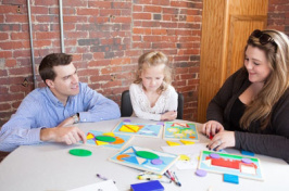 UNH neuropsychology students at a table with a young child 