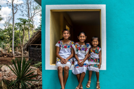 Sisters Angela, 12, Gelmy, 9, and Alexa Natali, 3, sitting on a window sill in Valladolid, Mexico