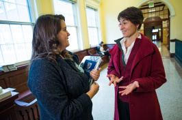 UNH professor Monica Chiu speaking with a student in Murkland Hall