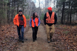 UNH Cooperative Extension's Karen Bennett with others in the woods 