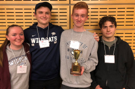 photo of four UNH students with trophy