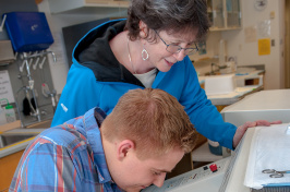 UNH Professor Emeritus Stacia Sower at work with a student 