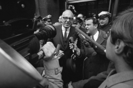 Dr. Benjamin Spock talks with newsmen outside the Federal Building in Boston, Jan. 29, 1968, after pleading innocent to charges of counseling young men to avoid the draft. (J. Walter Green/AP)