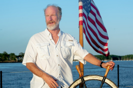 UNH professor of history Jeff Bolster driving a boat