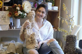 UNH student Cierra R. Vigue holding one of her ceramic sculptures