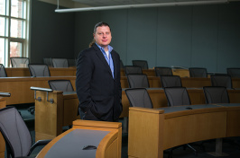 Professor Aktekin poses in a Paul College classroom