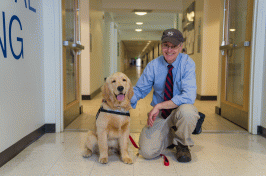 UNH professor Ray Cook and therapy-dog-in-training Tucker