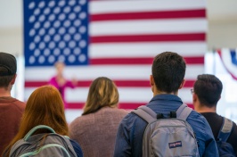 students in front of American flag