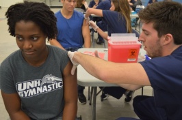 Person giving flu shot to patient