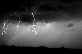 Three flashes of lightning emerge from the same cloud.