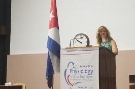 Associate professor of biological sciences and biotechnology Patricia Halpin chairing symposium in Havana, Cuba