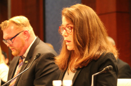Sharyn Potter testifying before Congress with male in background