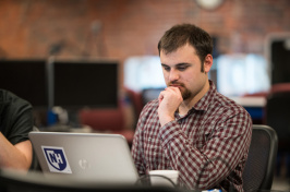 A UNH student working at a computer 