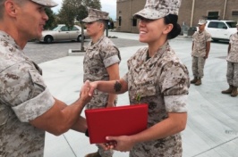 U.S. Marine Corps veteran Cayla PerkinsGoodrie acceping an award.