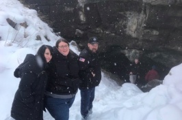 Anthropologist Amy Michael and law enforcement officers at the entrance to the cave where Joseph Henry Loveless's body was found