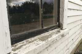 Photo showing a window with peeling, possibly hazardous lead-based paint.